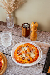 homemade pizza with sausages, cheese and vegetables
