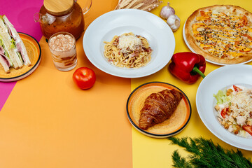 Italian pasta, pizza and caesar salad on bright backgrounds. moc