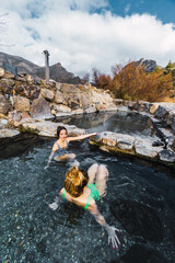 two people relaxing in natural hot springs
