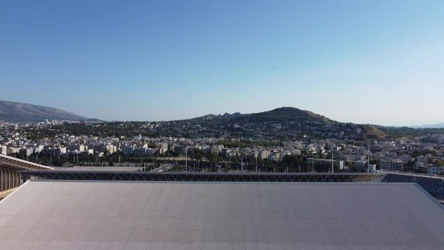Drone footage from the Olympic complex in Athens, Greece. Revealing shot of the nearby Filothei hill | 4K