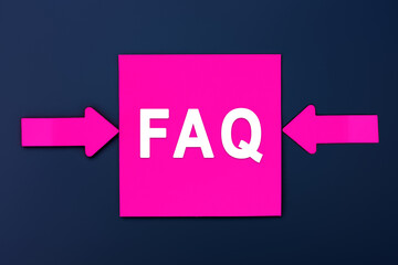 FAQ - Frequently Asked Questions - inscription of a magenta paper notes and two colorful arrows over a dark blue background. Top view. Instructions and rules on Internet sites