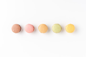 Colourful macaroons on white background. Top view