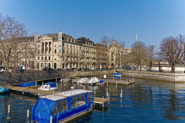 Scenic view of Limmat River with Minster Bridge and the skyline of the old town of City of Zürich on a sunny winter day. Photo taken February 9th, 2023, Zurich, Switzerland.