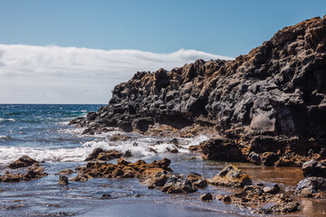 Landscape of sand and volcanic mountains by the sea in the Canary Islands