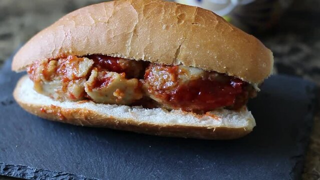 slow motion slider of tamale torta in red sauce. Mexican food. sandwich