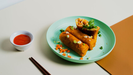 Indonesian traditional snack-2023, Risol with creamy ragout filling. snack cooked by frying, and garnished with carrot, sauce and celery on a white background