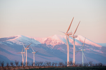 Wind turbine generators for renewable electricity production and snow mountain © WINDCOLORS