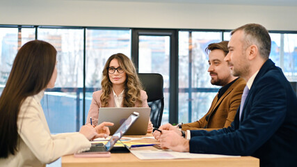 Business meeting in an office, workers discussing business affairs. Gadgets and papers on the table