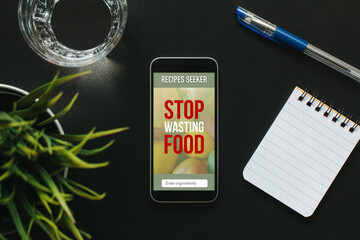Mobile phone with Stop Wasting Food message and recipes seeker app in the screen.