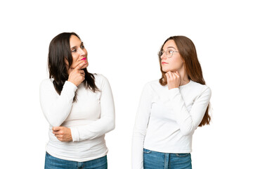 mother and daughter over isolated chroma key background standing and thinking an idea