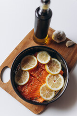 Raw salmon with lemon on a wooden desk