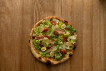 Juicy, fragrant delicious pizza on the table top view on a sunny day
