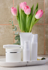 White plastic tube, jar for cosmetics. Container for gel, cream, tonic. Advertising and product promotion
