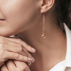 Woman Jewelery concept. Woman hands close up wearing rings, earrings and necklace modern...