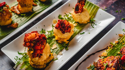 Asian spicy tuna tartare with potato and fuchka also with other dishes, sprinkle coriander leaves,...