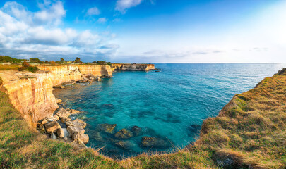 Picturesque seascape with white rocky cliffs, sea bay, islets and faraglioni near by beach Spiaggia della Punticeddha,