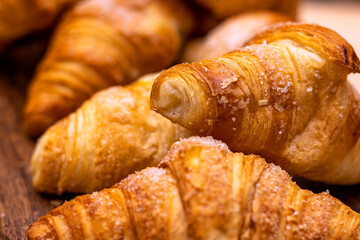 Croissant. Bakery. close-up of croissant stacked on wooden board.