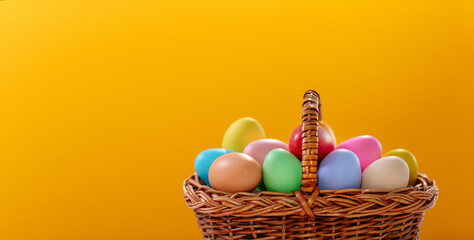 a basket full of easter colored eggs on a yellow background