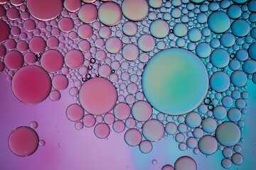 multi colored oil circles on the water, colorful background