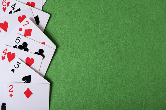 Playing cards on a green background with space for text