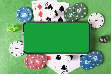 Mockup phone with chroma key and playing cards and poker chips in the casino