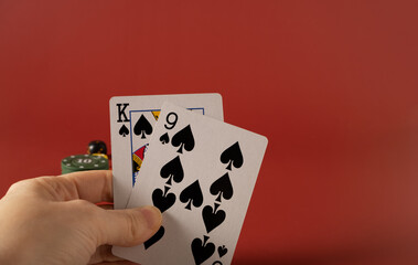 Playing poker, a combination of cards king and nine on a red background