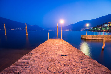 Pier on Lake Maggiore with Mountain in Dusk in Ascona, Ticino, Switzerland.