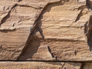 Stone texture background. Macro photo stylized old brickwork pattern uneven textured beautiful warm stone surface