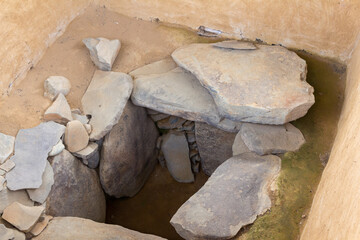 Entrance of a pre-columbian funeral tomb made of huge stones (megaliths) and adobe wall. San Agustin (San Agustín), Huila, Colombia.