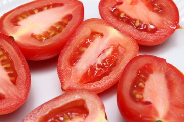 red tomatoes on a white background. halved tomatoes on white background. red natural food.