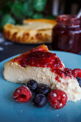 Cheesecake slice with strawberry jam, close up view