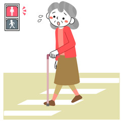 道路を渡り切れず信号が赤になって困っているシニア女性