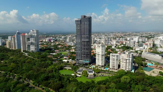 Anacaona 27 tower skyscraper with cityscape in background. Santo Domingo. Aerial orbiting