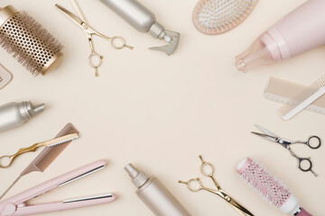 Various hair dresser tools on cream background with copy space