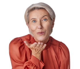 A happy mature caucasian woman blowing a kiss with her hands. Ageing female using body language to express love, kindness, flirting and affection with a gesture isolated on a png background.