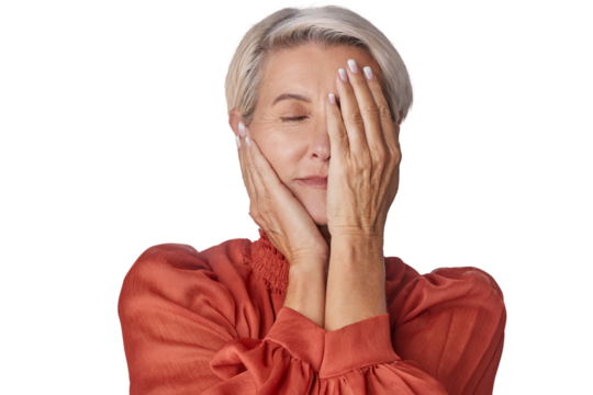 An adult senior woman touching her perfect skin. Beautiful mid 50s aged woman advertising facial anti age lift products isolated on a png background.