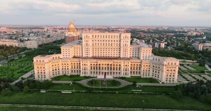 Palace of Parliament in Bucharest, Romania history Center aerial view at dawn in summer against blue sky