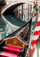 Fototapeta na wymiar Moored Gondola On One Of The Canals In Venice, Italy