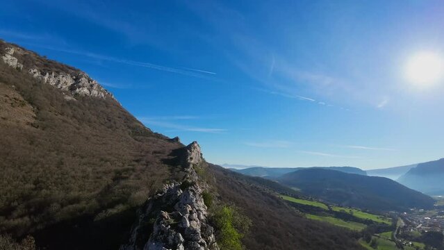 A large bird (vulture) takes flight when a drone approaches it. The image is in a difficult to access area, the top of a rocky mountain.