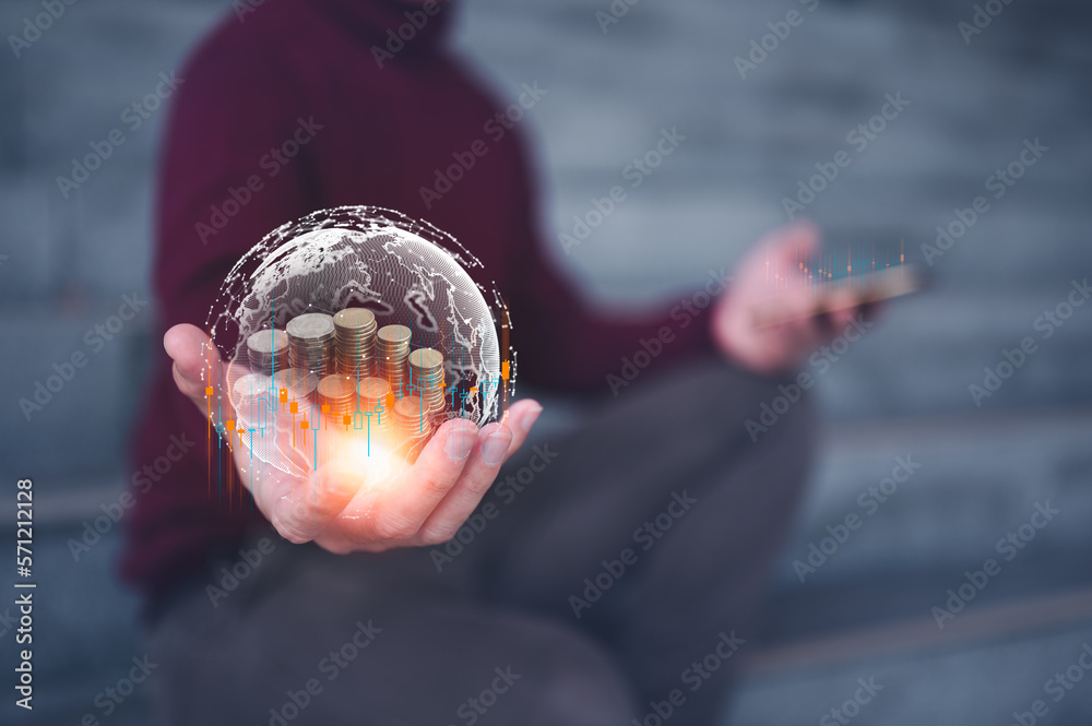 Wall mural investment and finance concept, businessman holding virtual glob and trading graph with blurred coins on hand, stock market, profits and business growth.