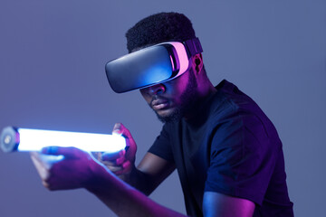 African American guy in Smart glasses of virtual reality. Augmented reality game, future technology, AI concept. VR. Neon light.