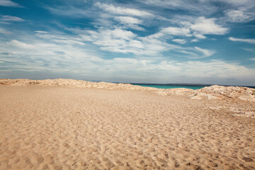 Close-up of sea sand wealth. Panoramic beach landscape. Inspire the skyline of a Caribbean pool. Cloudy sky - 571212546