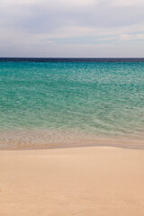 Close-up of sea sand wealth. Panoramic beach landscape. Inspire the skyline of a Caribbean pool. Cloudy sky