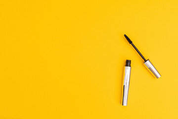 Silver mascara with yellow background