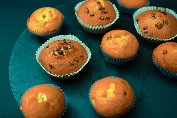 Bright orange cupcakes in an unusual colour with blue packaging