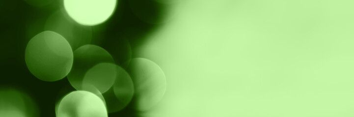 Blurred lights, green background, banner texture. Abstract bokeh with soft light header. Wide...