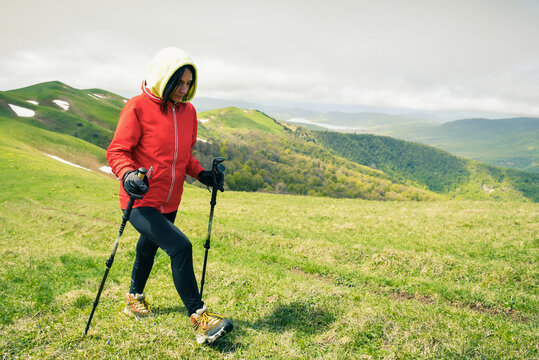 Close Up Female Woman Hike Up To Hill Top And Use Nordic Sticks For Stamina Outdoors In Spring With Beautiful Nature Background Panorama