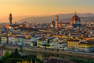 Fototapeta na wymiar The Florence cityscape with the Florence Cathedral and Palazzo Vecchio in an orange sunset.