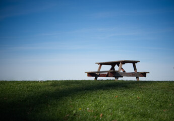 A lone picnic table resting in a flat, open landscape