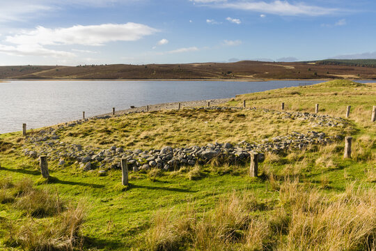 Timber circle or ring cairn or Brenig 44 with the burial mound Boncyn Arian or Brenig 45 behind it. Dated to 2000 - 1500 BC and located at Llyn Brenig reservoir in the Denbigh moors Wales